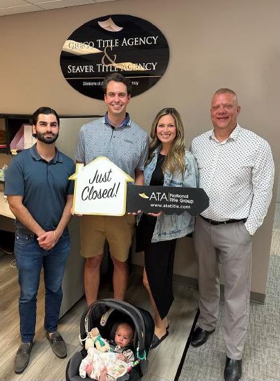 Stefano with a family holding a Just Closed sign