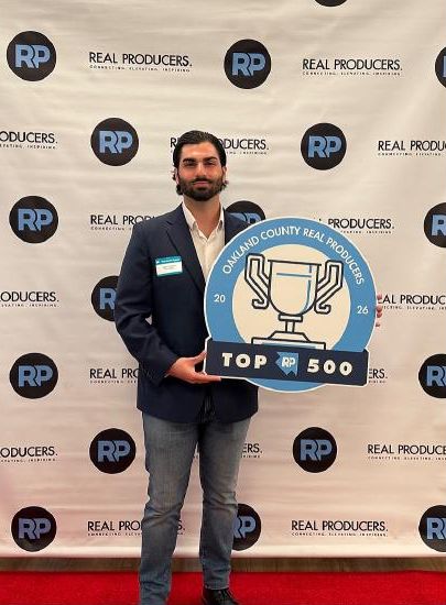Stefano holding the Real Producers Top 500 award